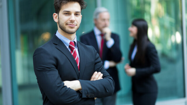 business team smiling outdoor modern urban setting scaled